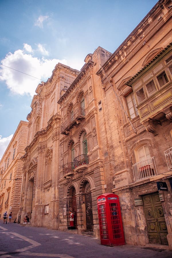 An old street with a red phone booth in Valletta Malta