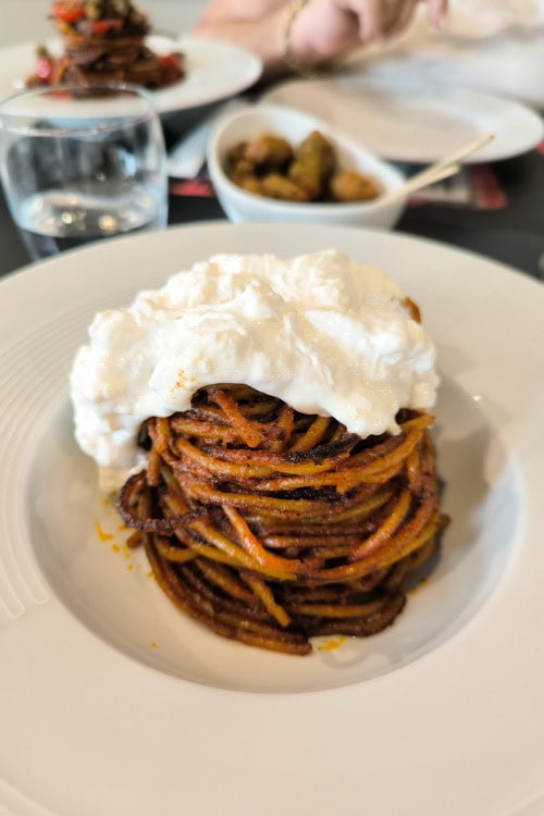 spaghetti all'assassina with stracciatella cheese on top in Bari Italy