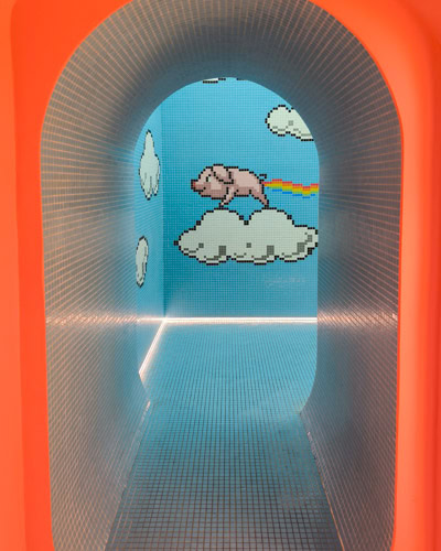 baby blue wall with pig at pop&roll public toilet in Budapest