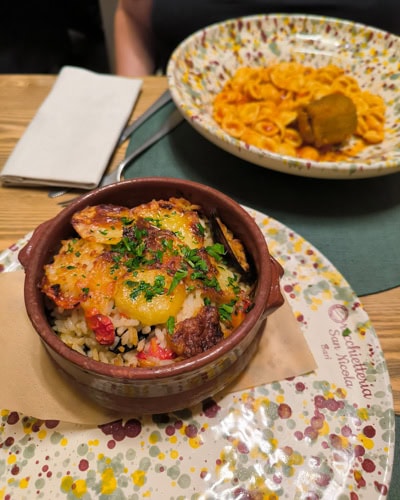Tiella (food) in a terracotta dish in Bari