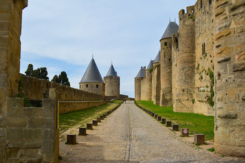 walking path in Carcassonne with city walls and turrets in the sides